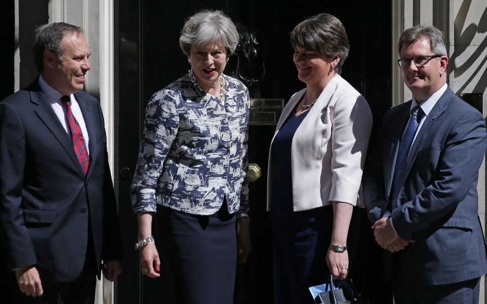 Theresa May (2L) poses for a picture with Democratic Unionist Party (DUP) leader Arlene Foster (2R), DUP Deputy Leader Nigel Dodds (L) and DUP MP Jeffrey Donaldson at 10 Downing Street - Credit: AFP/Daniel Leal-Olivas