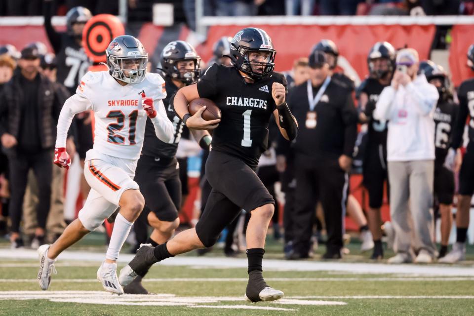 Corner Canyon’s Isaac Wilson runs away from Skyridge defense to score a touchdown in the 6A high school football championship at Rice-Eccles Stadium in Salt Lake City on Friday, Nov. 17, 2023. | Spenser Heaps, Deseret News