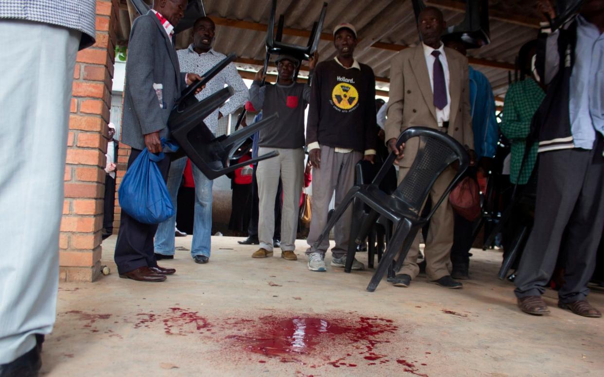 Blood is seen on the ground at the Movement for Democratic Change provincial office after fighting broke out - AFP