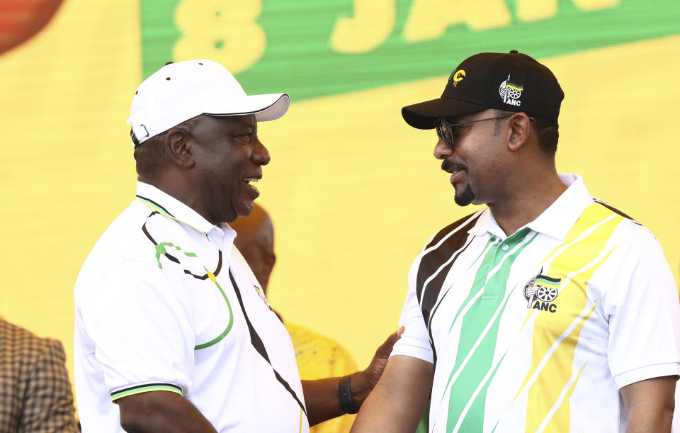 Ethiopian Prime Minister Abiy Ahmed Ali, right, talks with African National Congress (ANC) president and South African President Cyril Ramaphosa at the party's 108th birthday celebrations in Kimberley, South Africa, Saturday, Jan. 11, 2020. (AP Photo)