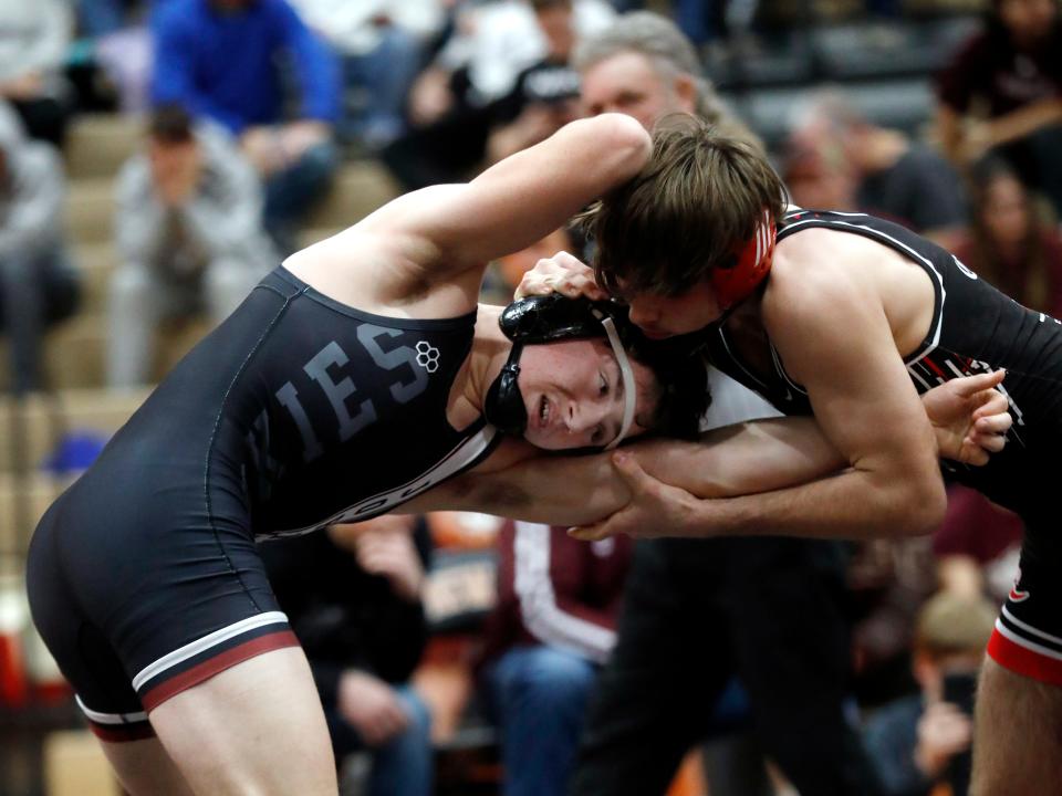 John Glenn's Owen Edwards, left, and Crooksville's Hunter Browning wrestle in the finals at 144 pounds during the Muskingum Valley League Tournament on Saturday at New Lexington High School.