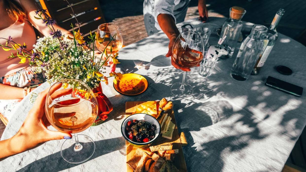 group of female friends drinking wine outside