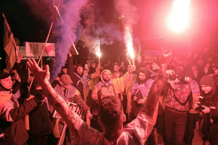 Demonstrators light flares during an antiwar protest.