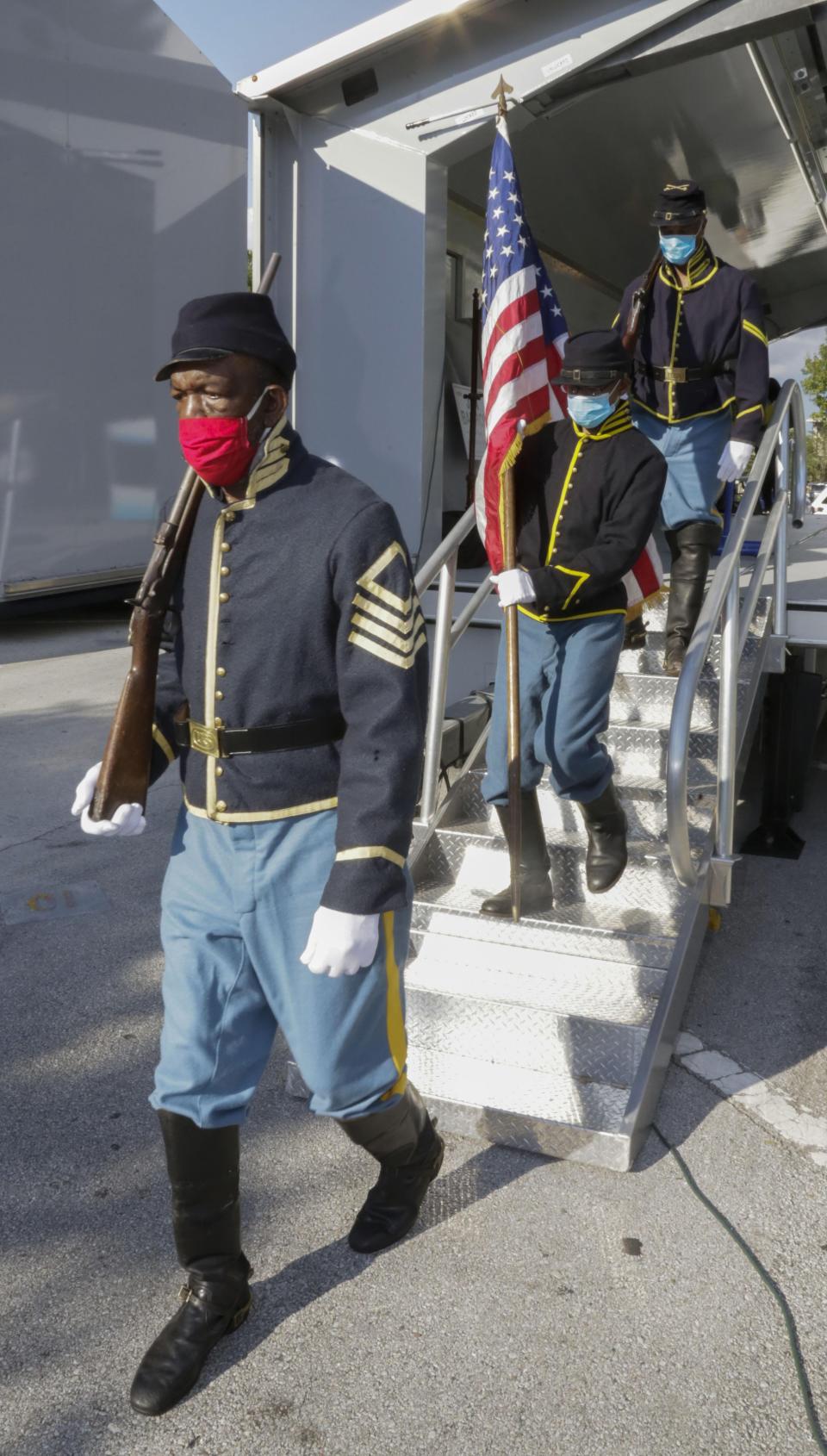 The Color Guard from the Buffalo Soldiers Florida representing the 3rd U.S. Colored Calvary, a civil war unit, remove the flag at the end of the 28 Juneteenth celebration at Munn Park in Lakeland. Lakeland and other cities across the county will observe Juneteenth with festivals, parades and galas.