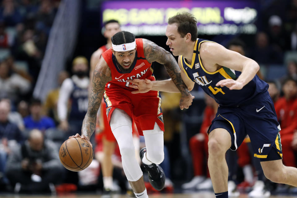 New Orleans Pelicans forward Brandon Ingram, left, is defended by Utah Jazz forward Bojan Bogdanovic, right, in the first half of an NBA basketball game in New Orleans, Monday, Jan. 6, 2020. (AP Photo/Tyler Kaufman)