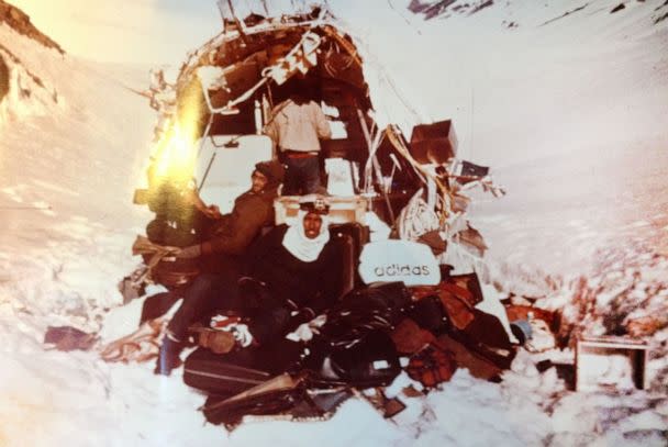 PHOTO: Mid-November 1972: Roy Harley (top), Roberto Canessa (L), and Antonio Vizintin (front) at the tail section while attempting to fix the airplane’s radio. To Roy’s left are the red baby shoes that Nando’s mother bought in Mendoza for her grandchild. (Obtained by ABC News)