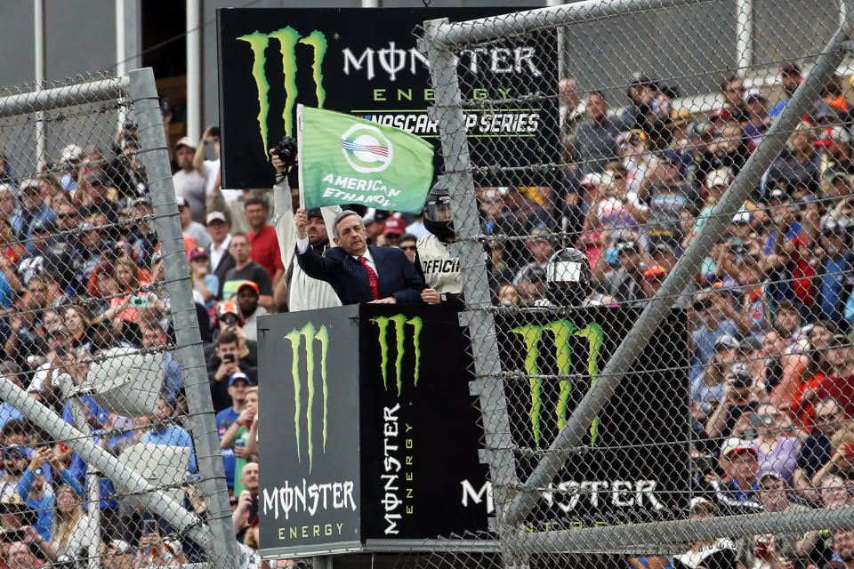 Pastor of First Baptist Church Dallas Dr. Robert Jeffress waves the green flag for the start of a NASCAR Cup Series auto race at Talladega Superspeedway, Sunday, Oct. 13, 2019, in Talladega, Ala. (AP Photo/Butch Dill)