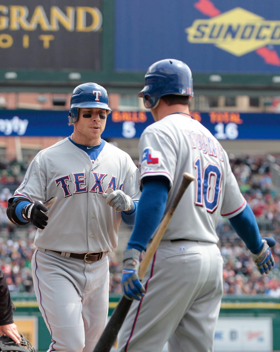 DETROIT, MI - APRIL 22: Josh Hamilton #32 of the Texas Rangers hits a first inning solo home run and is congratulated by teammate Michael Young #10 during the game against the Detroit Tigers at Comerica Park on April 22, 2012 in Detroit, Michigan. (Photo by Leon Halip/Getty Images)
