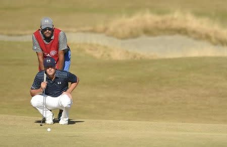 Jun 21, 2015; University Place, WA, USA; Jordan Spieth and caddie Michael Greller line up a putt on the 14th green in the final round of the 2015 U.S. Open golf tournament at Chambers Bay. Mandatory Credit: John David Mercer-USA TODAY Sports