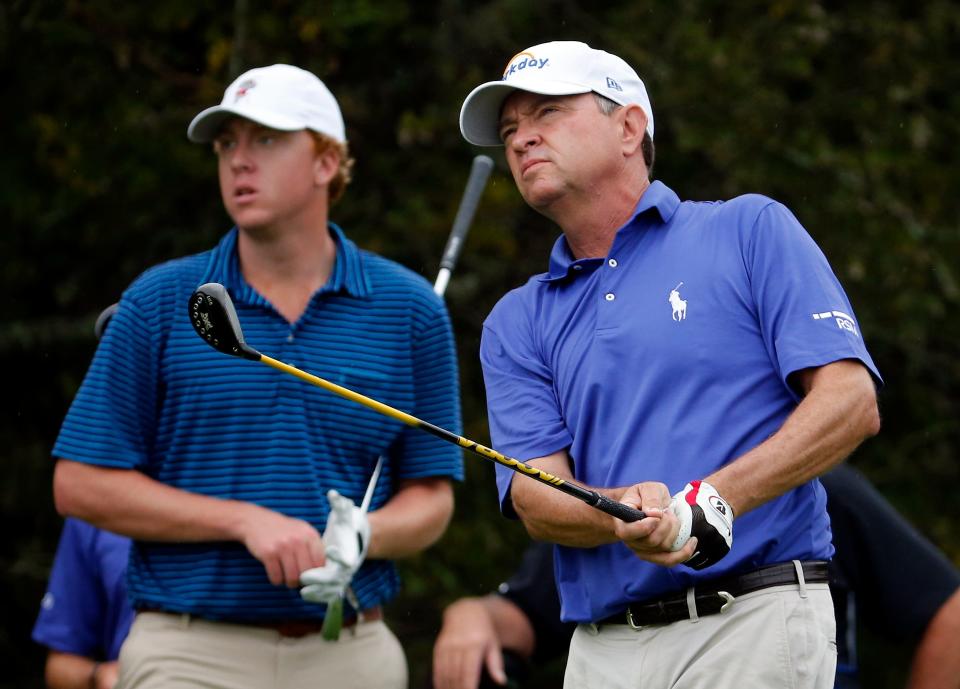 Davis Love III (right) watches his shot during the the 2015 RSM Classic at the Sea Island Club. He played with his son Dru (left).