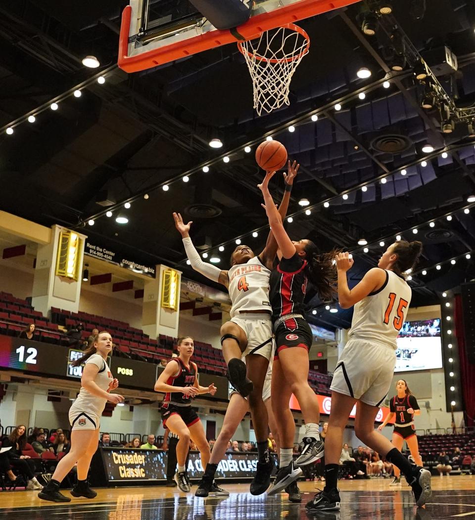 White Plains' Sequoia Layne (4) and Rye's Piper Tenney (13) reach for a rebound during girls basketball action at the Slam Dunk Showcase at the Westchester County Center in White Plains on Friday, Jan 5, 2024. White Plain won 57-50.