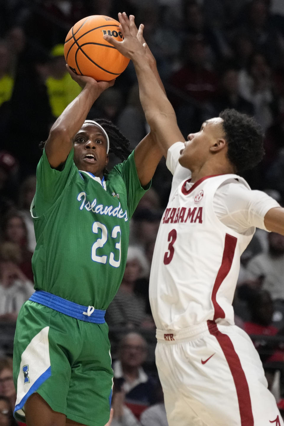 Texas A&M-Corpus Christi guard Ross Williams (23) has his shot blocked by Alabama guard Rylan Griffen (3) in the first half of a first-round college basketball game in the NCAA Tournament in Birmingham, Ala., Thursday, March 16, 2023. (AP Photo/Rogelio V. Solis)