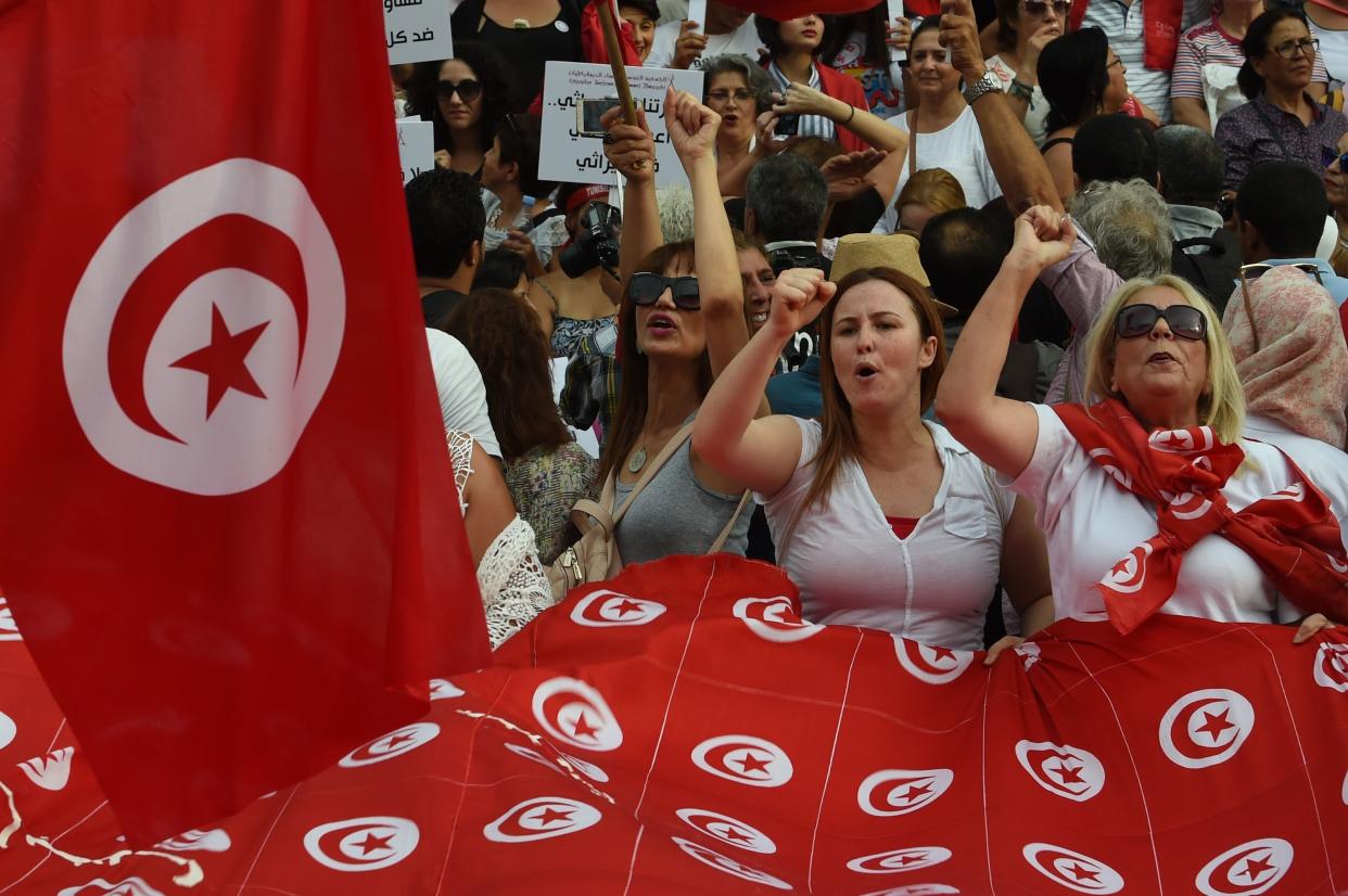 Tunisian women chant slogans and wave their national flags during a demonstration to mark Tunisia&rsquo;s Women&rsquo;s Day on Aug. 13, 2018. (Photo: FETHI BELAID VIA GETTY IMAGES)