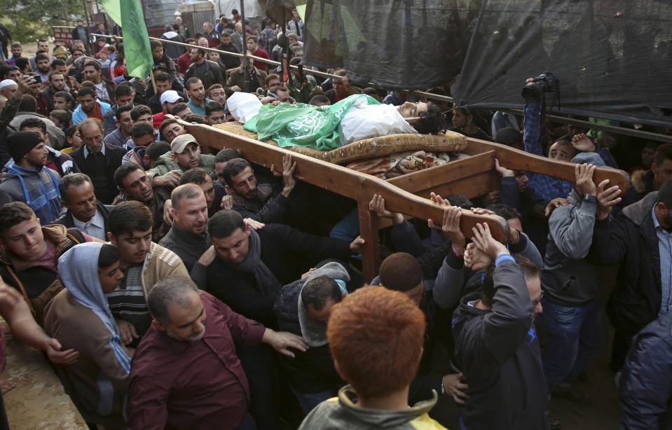 Mourners carry the body of Palestinian fisherman Nawaf Al-Attar, 20, who was shot and killed by Israeli troops on the beach near the border with Israel, during his funeral in Beit Lahiya, northern Gaza Strip, Wednesday, Nov. 14, 2018. (AP Photo/Adel Hana)