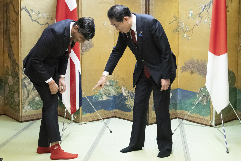 XFP British Prime Minister Rishi Sunak shows off his socks to Japanese Prime Minister Fumio Kishida, which has the name of Kishida's favorite baseball team, Hiroshima Toyo Carp, on them, during their bilateral meeting in Hiroshima ahead of the G7 Summit in Japan, Thursday May 18, 2023. (Stefan Rousseau, Pool via AP)