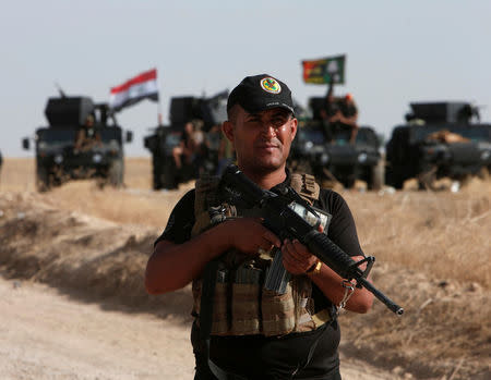 A member of the Iraqi security forces stands with his weapon on the east of Mosul during preparations to attack Mosul, Iraq, October 15, 2016. REUTERS/Azad Lashkari