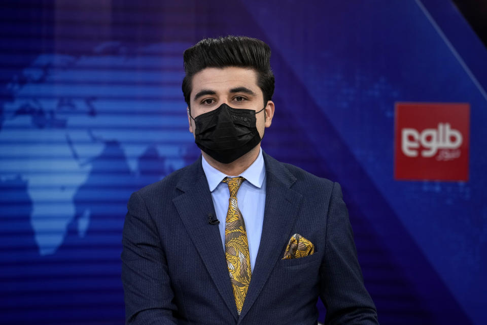 TV anchor Nesar Nabil wears a face mask to protest the Taliban's new order that female presenters cover their faces, as he reads the news on TOLOnews, in Kabul, Afghanistan, Sunday, May 22, 2022. Afghanistan's Taliban rulers have begun enforcing an order requiring all female TV news anchors in the country to cover their faces while on-air. The move Sunday is part of a hard-line shift drawing condemnation from rights activists. (AP Photo/Ebrahim Noroozi)