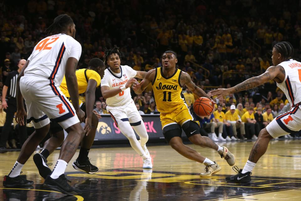 Iowa’s Tony Perkins (11) drives to the basket against Illinois Sunday, March 10, 2024 at Carver-Hawkeye Arena in Iowa City, Iowa.