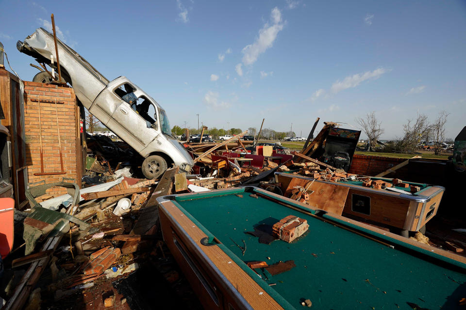 A pickup truck rests on top of debris from Chuck's Dairy Cafe in Rolling Fork, Mississippi, on March 25, 2023.