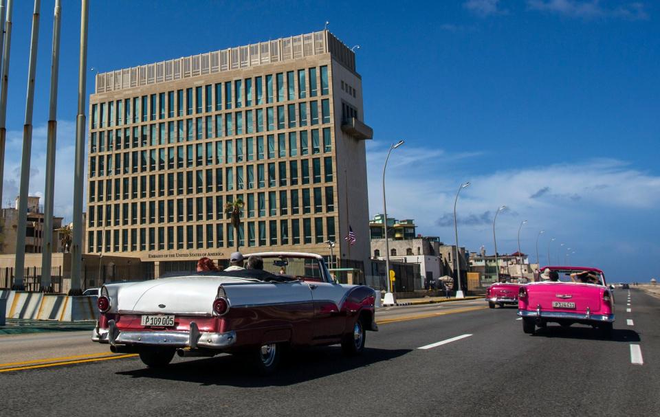 In this Oct. 3, 2017, file photo, cars pass the U.S. Embassy in Havana, Cuba. Many U.S. diplomats, intelligence officers and military personnel around the world have suffered from headaches and other maladies in what has been called the &quot;Havana Syndrome&quot; because the first cases affected personnel in 2016 at the embassy.