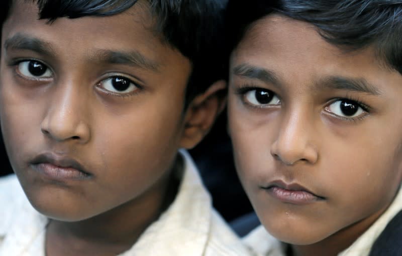 Wahaj and Waleed (6), look on during an event to attempt to break the world record for the biggest gathering of twins in Colombo