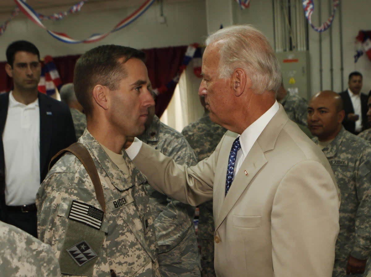 Then US vice president Joe Biden (right) talks with his son, US Army Capt Beau Biden (left) at Camp Victory on the outskirts of Baghdad on 4 July 2009 (AFP via Getty Images)