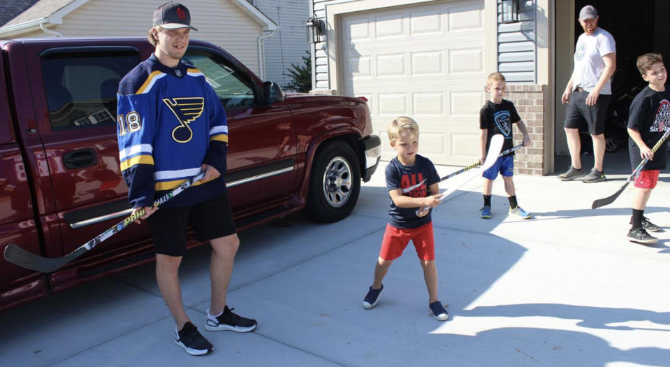 Robert Thomas puts his skills to the test against members of the Hanlon family. (stlouisblues.com)