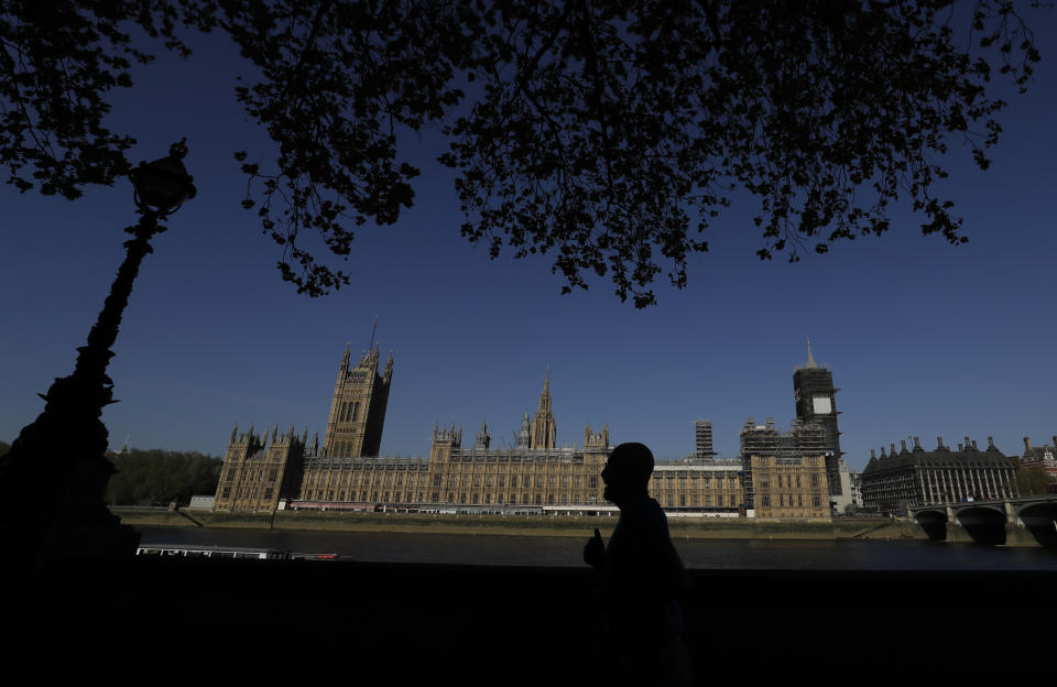 The sun shines above Britain's Houses of Parliament as the country is in lockdown to help curb the spread of coronavirus, in London, Tuesday, April 21, 2020. Britain's Parliament is going back to work, and the political authorities have a message for lawmakers: Stay away. U.K. legislators and most parliamentary staff were sent home in late March as part of a nationwide lockdown to slow the spread of the new coronavirus. With more than 16,500 people dead and criticism growing of the government’s response to the pandemic, legislators are returning Tuesday — at least virtually — to grapple with the crisis. (AP Photo/Kirsty Wigglesworth)