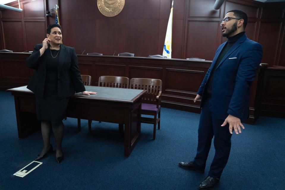 Roger Williams University Law Dean Lorraine Lalli chats with third-year RWU law student Jonte' McKenzie in the law school's mock courtroom.