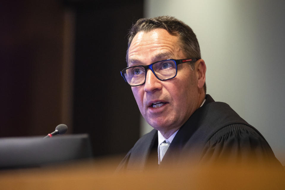 Judge Evangelos Thomas presides at the Whakaari White Island eruption trial at the Auckland Environment Court, in Auckland, New Zealand, Thursday July 13, 2023. Helicopter pilot, Brian Depauw, said Thursday he and two of his passengers had escaped serious injury by jumping into the ocean when a New Zealand volcano erupted in 2019, killing 22. (Nick Monro/Pool Photo via AP)