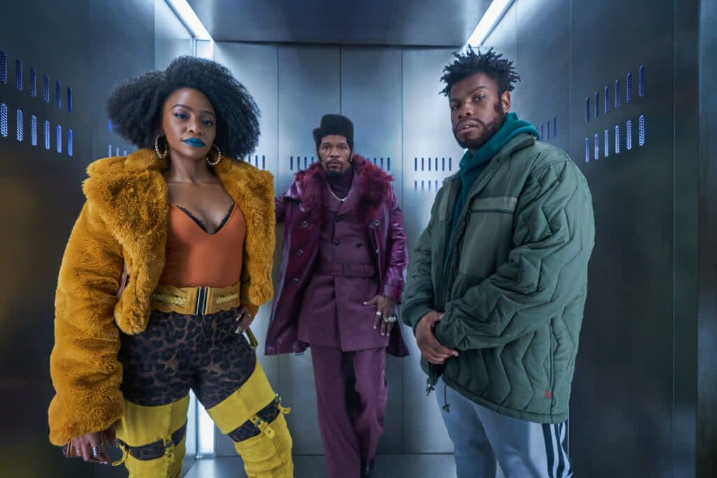 (Left to right) The stars of “They Cloned Tyrone”: Teyonah Parris as Yo-Yo, Jamie Foxx (producer) as Slick Charles, John Boyega as Fontaine. (Photo credit: Parrish Lewis/Netflix)