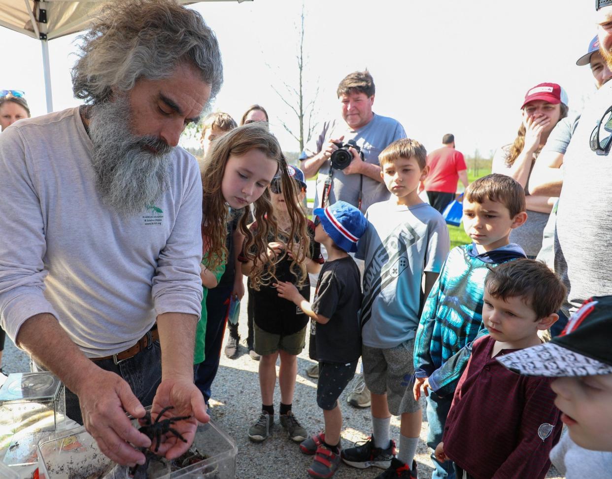 Mark Berman, Bugman Education and Science Shows founder,  displays various spiders to the crowd April 23 during Grove City's Earth Day celebration at Fryer Park.