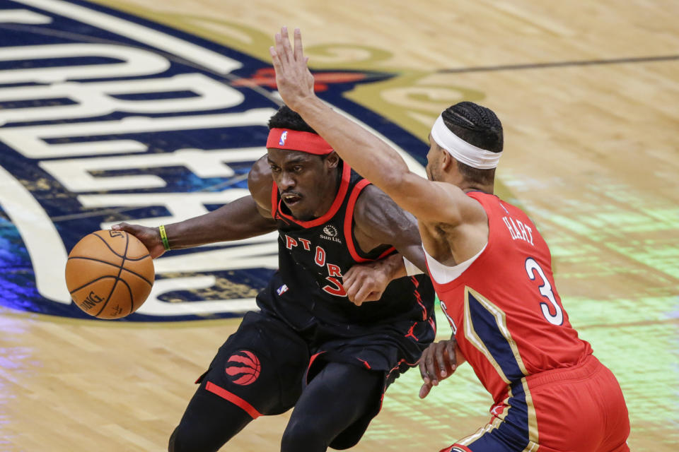 Toronto Raptors forward Pascal Siakam, left, drives to the basket as New Orleans Pelicans guard Josh Hart, right, defends during the first half of an NBA basketball game on Saturday, Jan. 2, 2021, in New Orleans. (AP Photo/Butch Dill)