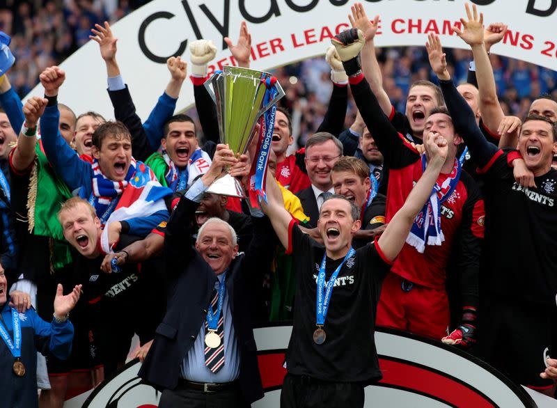 FILE PHOTO: Rangers' manager Smith and team captain Weir hoist Scottish Premier League 2010/2011 season winner's trophy in Scotland