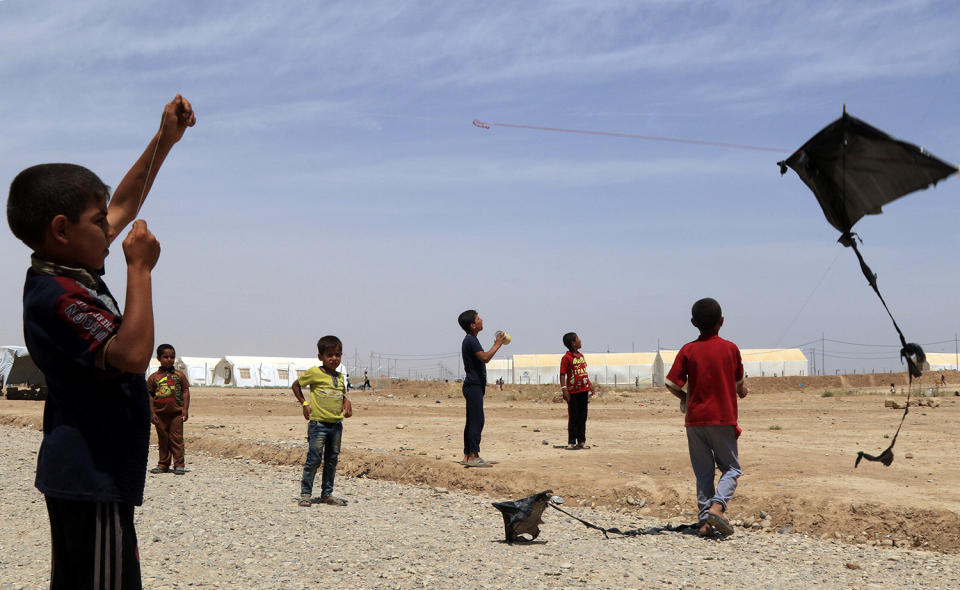 A displaced boy plays at Hammam al-Alil camp south of Mosul