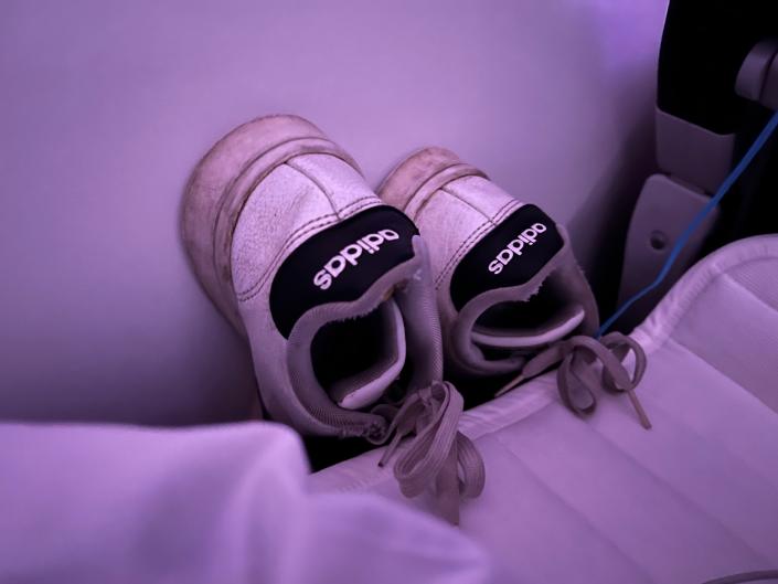 My shoes stored by the bed.