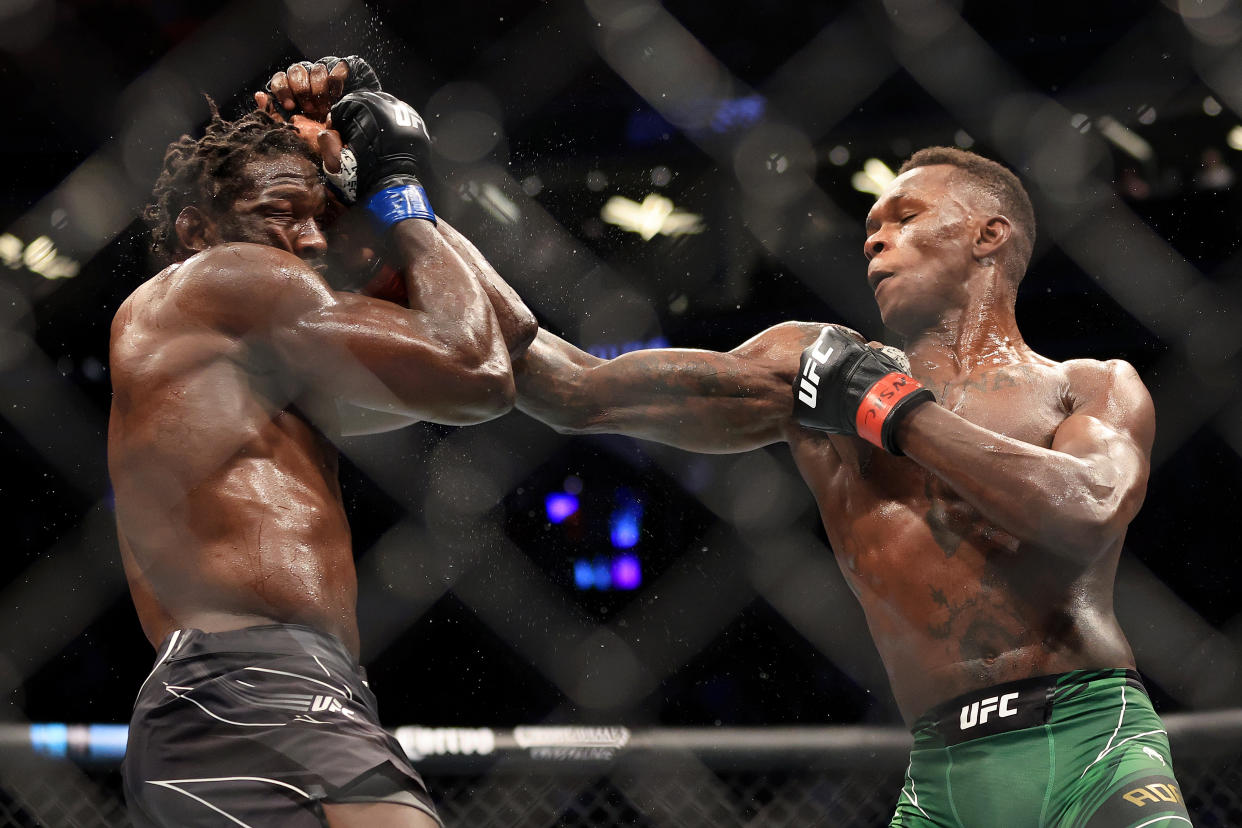 LAS VEGAS, NEVADA - JULY 02: Israel Adesanya (R) of Nigeria punches Jared Cannonier in their middleweight title bout during UFC 276 at T-Mobile Arena on July 02, 2022 in Las Vegas, Nevada. (Photo by Carmen Mandato/Getty Images)