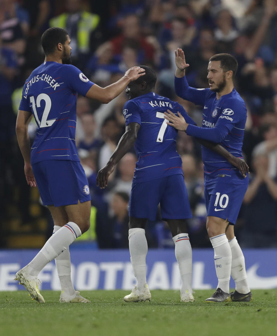 Chelsea's N'Golo Kante, centre, celebrates scoring his side's first goal during the English Premier League soccer match between Chelsea and Burnley at Stamford Bridge stadium in London, Monday, April 22, 2019. (AP Photo/Kirsty Wigglesworth)