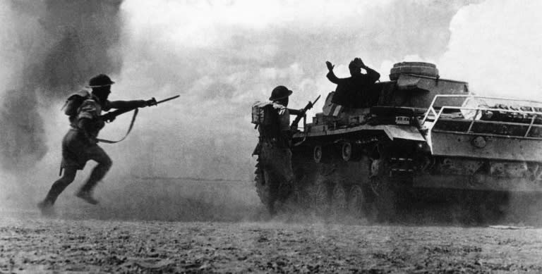 Two soldiers belonging to the Commonwealth and Allied forces aim at a German soldier surrendering atop his tank 25 October 1942 during the Battle of El Alamein. The victory in Egypt proved a turning point in the war for the Allies