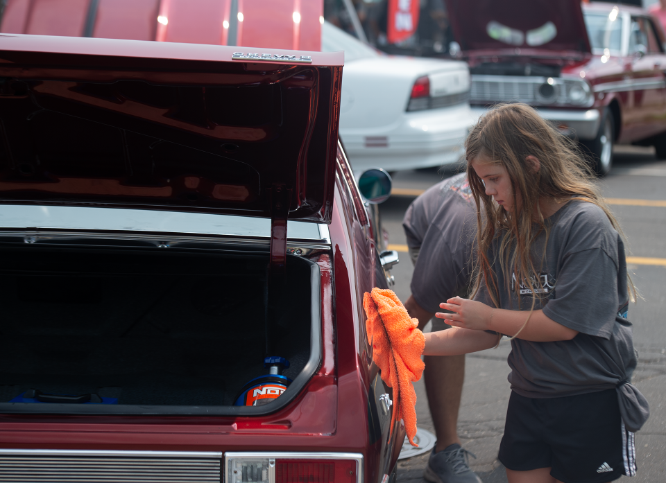 Danica Di Vencenzo, 10, helps detail her grandfather John Obeisk's 1968 Chevy Nova at Octane Nights car show in Ravenna.