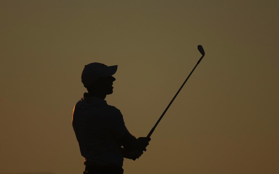 Rory McIlroy of Northern Ireland warms up on the range during the second round