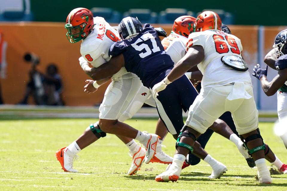 Florida A&M quarterback Jeremy Moussa (8) is sacked by Jackson State linebacker Nyles Gaddy (57) during the first half of the Orange Blossom Classic NCAA college football game, Sunday, Sept. 4, 2022, in Miami Gardens, Fla. (AP Photo/Lynne Sladky)