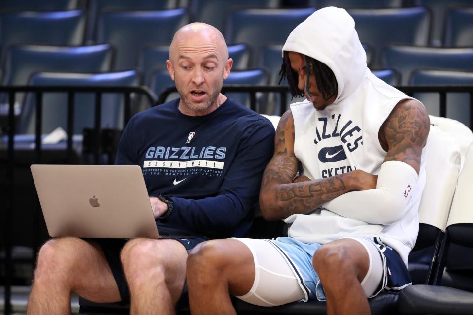 Grizzles guard Ja Morant (12) watches game strategy video clips with assistant coach Blake Ahearn prior to a game against the Hornets this week.