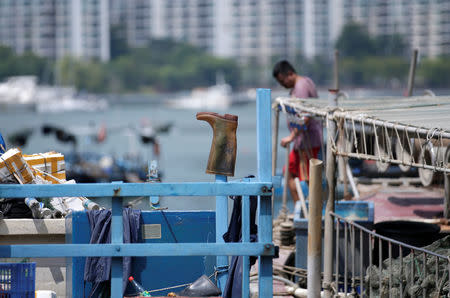 A rain boot is seen on an anchored boat at a fishing harbour, as Typhoon Mangkhut approaches, in Shenzhen, China September 15, 2018. REUTERS/Jason Lee