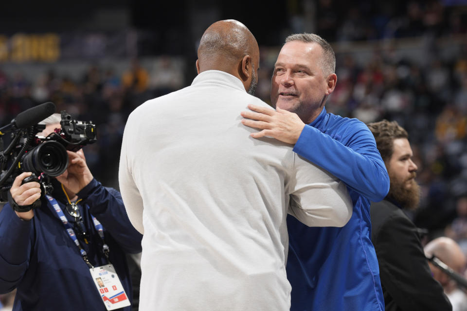 Denver Nuggets head coach Michael Malone, right, greets Washington Wizards head coach Wes Unseld Jr. during an NBA basketball game Wednesday, Dec. 14, 2022, in Denver. Unseld served as an assistant coach for Malone in Denver. (AP Photo/David Zalubowski)