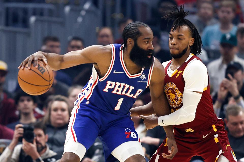 Philadelphia 76ers' James Harden (1) works against Cleveland Cavaliers' Darius Garland during the first half of an NBA basketball game Wednesday, March 16, 2022, in Cleveland. (AP Photo/Ron Schwane)
