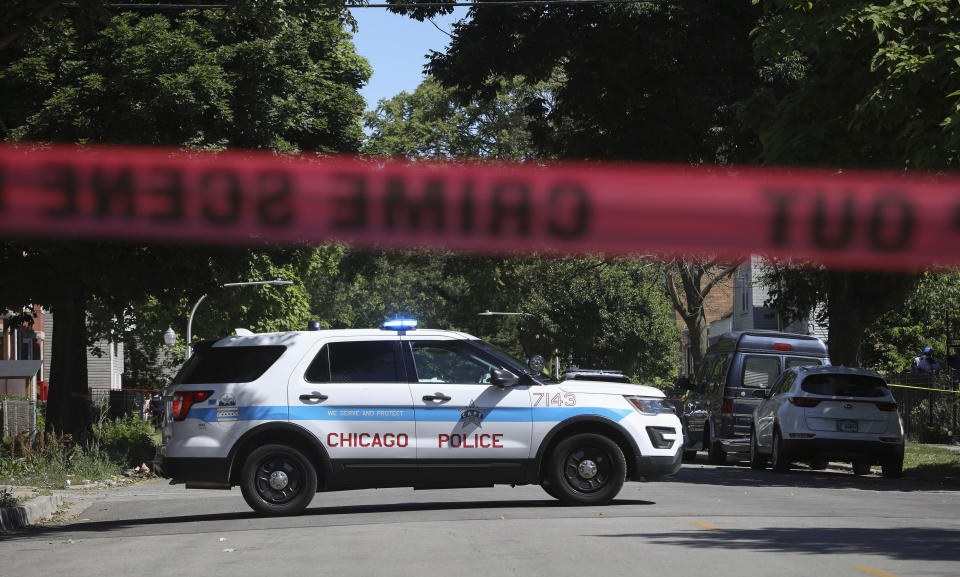 Police tape marks off a Chicago street as officers investigate the scene of a fatal shooting in the city's South Side on Tuesday, June 15, 2021. An argument in a house erupted into gunfire early Tuesday, police said. (AP Photo/Teresa Crawford)