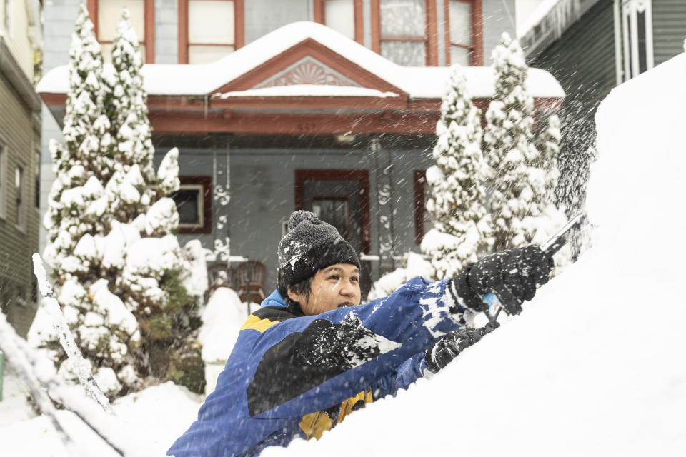 Al Antolin clears his car of snow Saturday, Nov. 19, 2022 in Buffalo, N.Y. Residents of northern New York state are digging out from a dangerous lake-effect snowstorm that had dropped nearly 6 feet of snow in some areas and caused three deaths. The Buffalo metro area was hit hard, with some areas south of the city receiving more than 5 feet by early Saturday. (Libby March /The Buffalo News via AP)