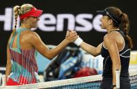 Germany's Angelique Kerber (L) shakes hands with Romania's Alexandra Dulgheru after Kerber won their second round match at the Australian Open tennis tournament at Melbourne Park, Australia, January 21, 2016. REUTERS/Jason Reed