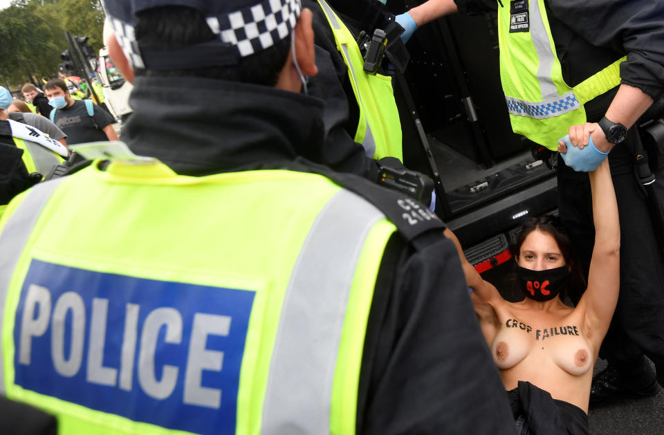 SENSITIVE MATERIAL. THIS IMAGE MAY OFFEND OR DISTURB Police officers remove an Extinction Rebellion climate activist after they had attached themselves to the Houses of Parliament, during a protest in London, Britain, September 10, 2020. REUTERS/Toby Melville